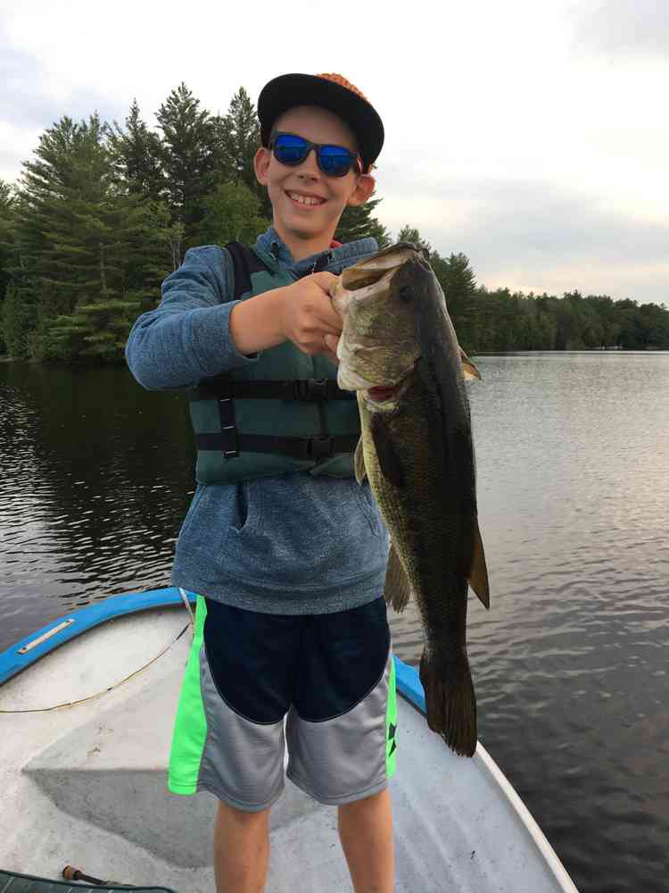 Boy holding a large bass