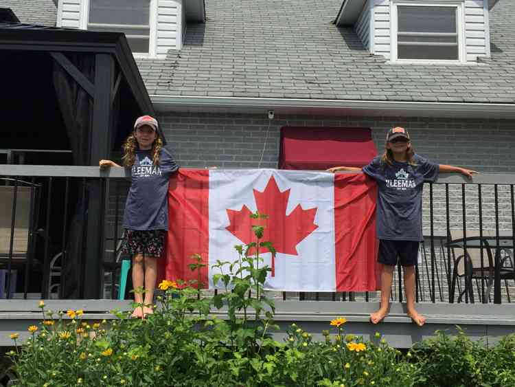 Two girls with the flag on Canada day