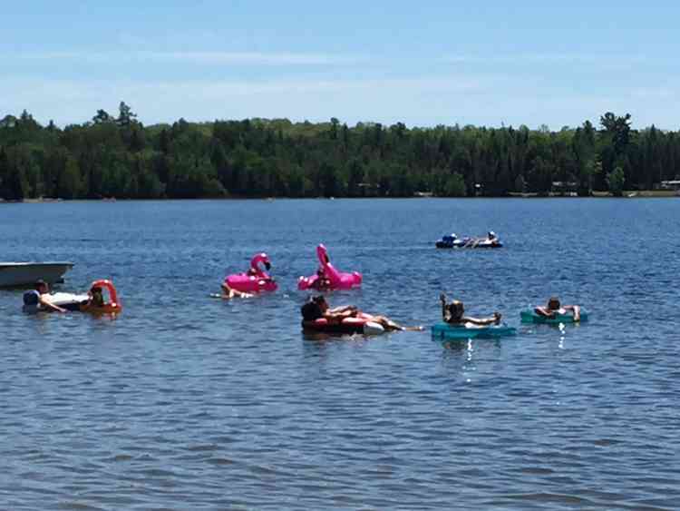Cottagers floating on inflatables on the lake